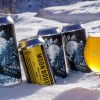 cans of Moon Booter IPA in the snow.