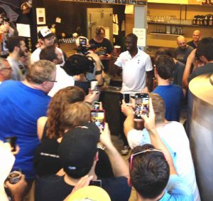 Tottenhan superstar Ledley King hoists a pint with the crowd. 