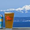 A pint of Pike Brewing's beer with mountains in the background.