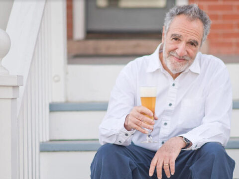 Charlie Papazian with a beer.