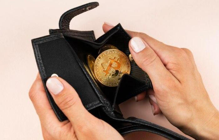 Gold bitcoin in a wallet.