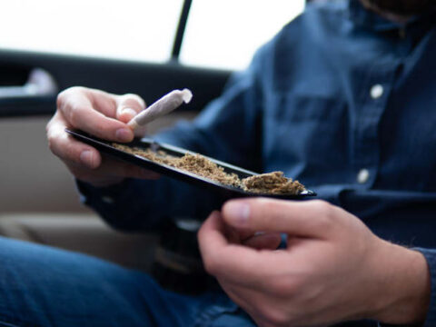 person with a tray and a joint.