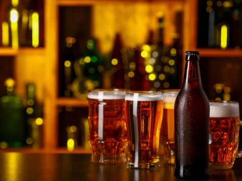 A craft brewery lounge setting with beer bottles and glasses of beer