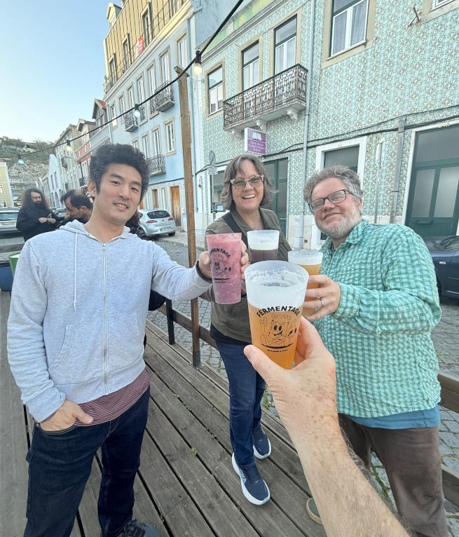 Three friends enjoying beers at Fermentage in Lisbon