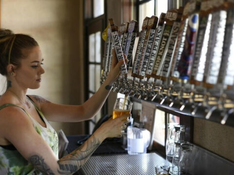 A Woman working at a brewery taproom