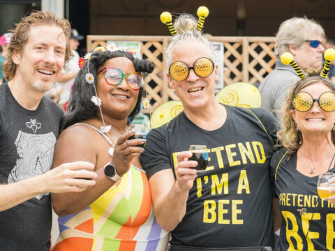 four people hoisting beers at a the washington brewers festival