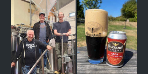 A group of people standing in a brewery