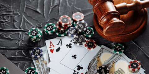 Poker chips, playing cards, cash, and a judge’s gavel symbolizing global gambling law changes.