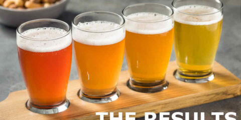 A flight of beer tasters with peanuts in the background