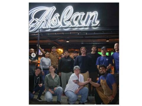 Aslan Brewing grand opening new Seattle location on April 1st Group of people in front of a brewery sign