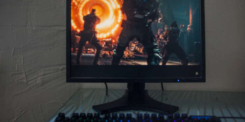 How to Start Playing CS2: Your First Steps That Matter, A Beer Lover’s Take Monitor showing a CS2-style action scene with an RGB keyboard, capturing a relaxed beer-lover gaming vibe.