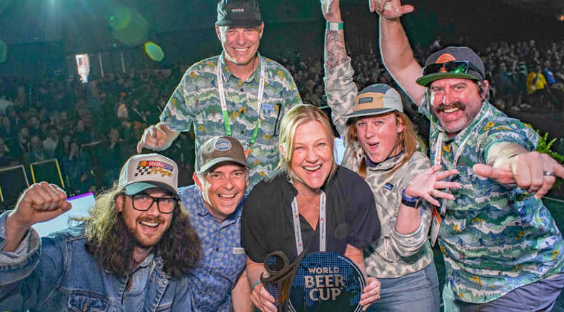 a group of people celebrate a win at the world beer cup
