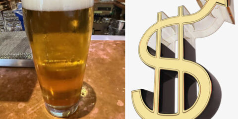 A pint of beer on a bar with a dollar sign next to it