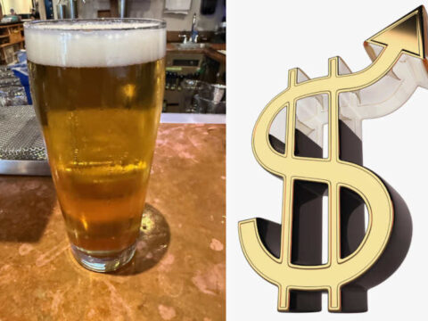 A pint of beer on a bar with a dollar sign next to it