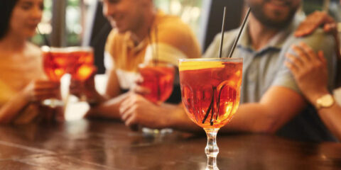 Friends at a table enjoying cocktails