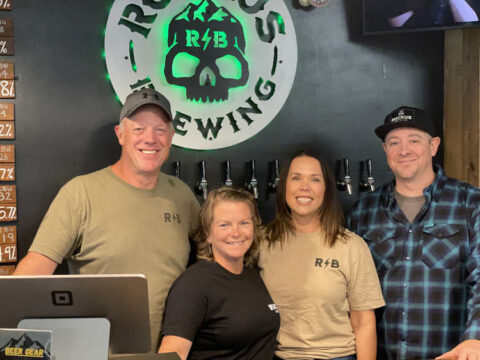 Exploring the Boise Beer Scene – a Guest Contribution Four people standing behind a bar at a brewery