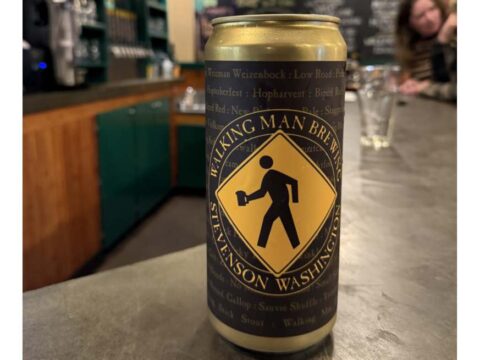 A crowler of beer sitting on a bar top at Walking Man Brewing