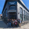The New Version of Boundary Bay Brewery Reopens Today in Bellingham A group of people standing in front of a new brewery and pub.