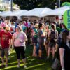 A crowd enjoying a cider festival on a sunny day
