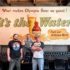 Leotucky Lager: a South Sound Mashup 130 Years in the Making Three men in front of a historic beer billboard