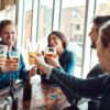 Can Your Friendship Group Influence Your Drinking Habits? Friends enjoying drinks together at a pub, highlighting how social circles can influence drinking habits and shared behaviors.