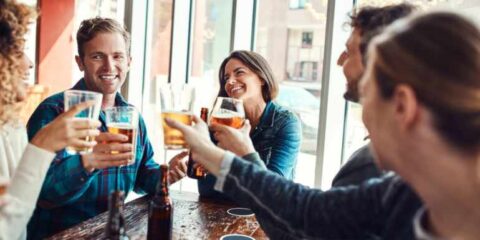 Can Your Friendship Group Influence Your Drinking Habits? Friends enjoying drinks together at a pub, highlighting how social circles can influence drinking habits and shared behaviors.
