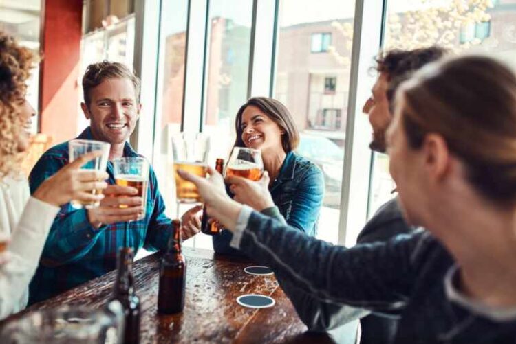 Can Your Friendship Group Influence Your Drinking Habits? Friends enjoying drinks together at a pub, highlighting how social circles can influence drinking habits and shared behaviors.