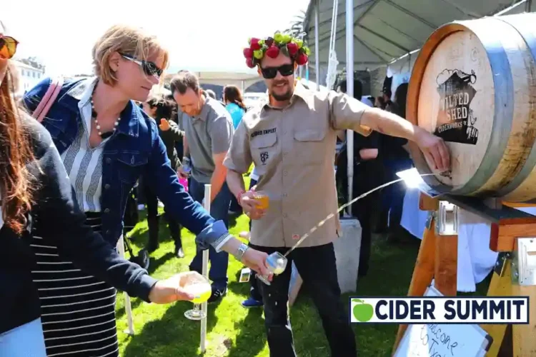 TICKET GIVEAWAY – Cider Summit Seattle Returns for a 15th Delicious Year A woman filling a glass of cider straight from the barrel
