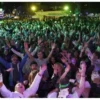 A crowd of people whooping it up at a beer festival