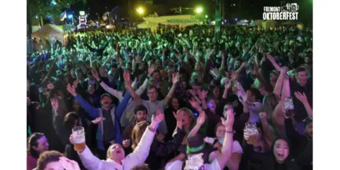 A crowd of people whooping it up at a beer festival