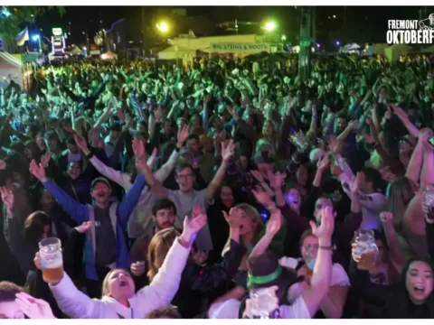 A crowd of people whooping it up at a beer festival