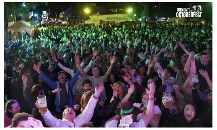 A crowd of people whooping it up at a beer festival