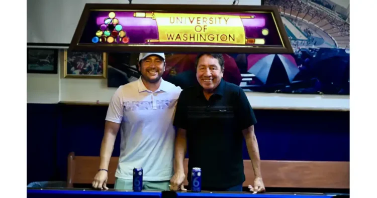 Two men standing in a bar and leaning on a pool table