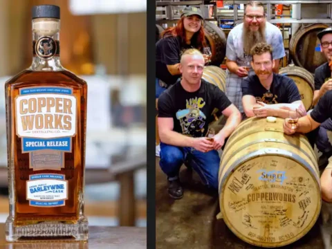 Copperworks Distilling and Urban Family Brewing, Sitting in a Tree A group of people crouched around a barrel of whiskey