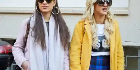 Why Copying Other People’s Style Is A Normal Part Of Finding Your Own Two stylish women wearing fashionable outfits and sunglasses, illustrating how copying others’ style can be part of finding your own personal fashion identity.
