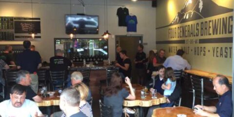A crowd enjoying beers at a brewery taproom