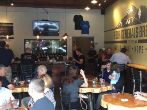 A crowd enjoying beers at a brewery taproom