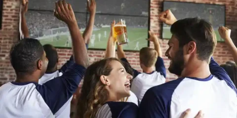 Craft Beer and Sports Culture: How Taprooms Are Evolving in Washington Craft beer and sports fans celebrating together in a Washington taproom while watching a soccer match on large screens.