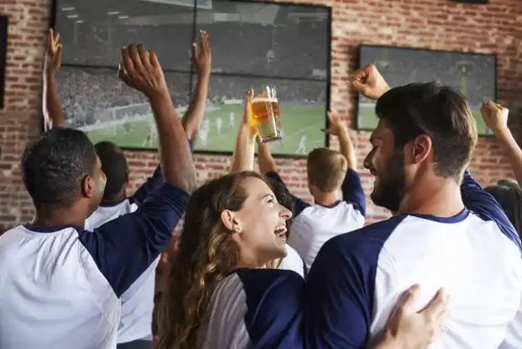 Craft Beer and Sports Culture: How Taprooms Are Evolving in Washington Craft beer and sports fans celebrating together in a Washington taproom while watching a soccer match on large screens.