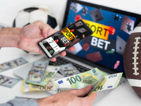 Top Sportsbook Software for Bookies: Risk Controls, Live Betting, and Provider Quality Person using sportsbook software for live sports betting with cash and sports equipment.