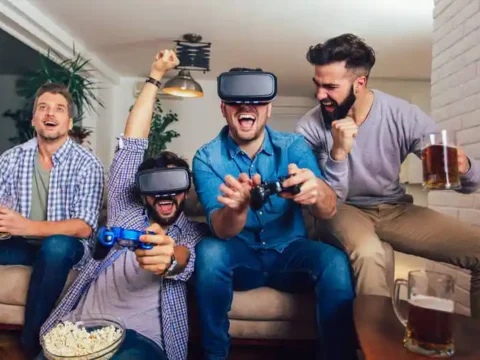 Gamers wearing VR headsets and drinking beer while playing a video game with adaptive difficulty.