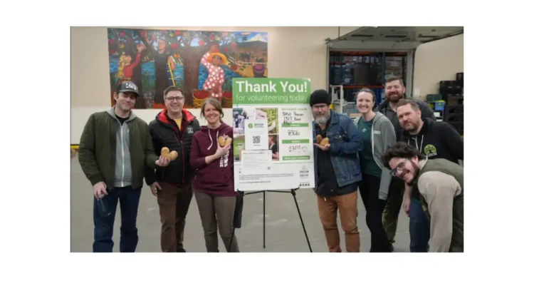 A group of people standing around a Donation sign