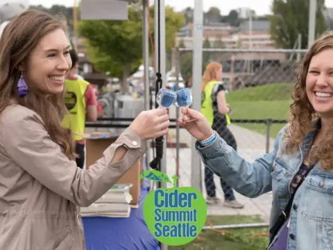 Final Countdown for Cider Summit Seattle on September 11th and 12th Two friends enjoying cider at a festival