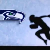 Seattle Seahawks logo alongside a silhouette of a football player running.