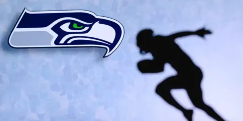 Moneyline, Spread, Totals: Seahawks Betting Terms for Beer Fans Seattle Seahawks logo alongside a silhouette of a football player running.