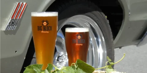 Big Block Brewing Is Closing Its Redmond Location, but It’s Not Bad News Two pints of beer in the foreground and the fender of a classic car in the background
