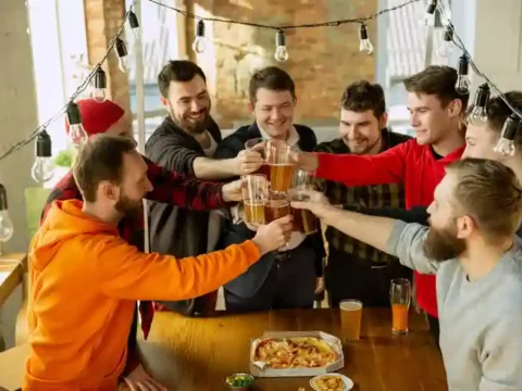The New Math of Brewery Clubs Friends raising beer glasses together at a brewery club gathering.