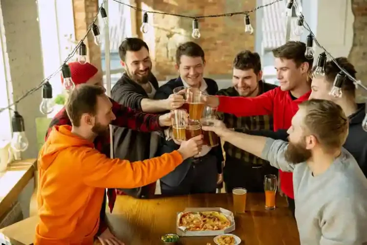 The New Math of Brewery Clubs Friends raising beer glasses together at a brewery club gathering.