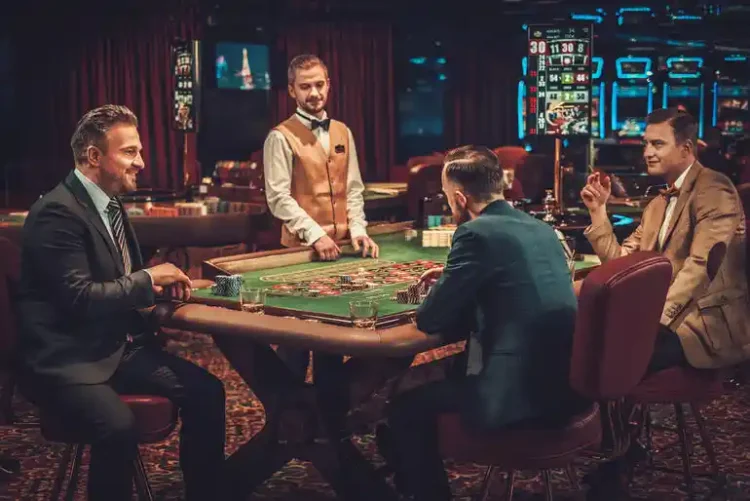 Group of players gathered around a casino table with a dealer, highlighting the social entertainment and experiences beyond casino games.