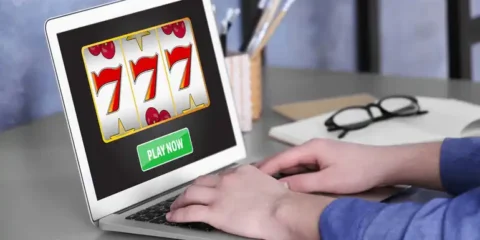 How to Play Golden 777 Slot for Real Money: Rules, Symbols and Free Spins A Man using a laptop to play an online casino game at home.